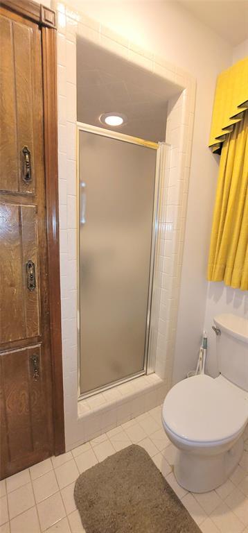 1117 Moose St, Yukon, OK 73099 - full bathroom with a stall shower and tile patterned flooring