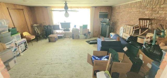 1117 Moose St, Yukon, OK 73099 - living area featuring carpet flooring, brick wall, a ceiling fan, and a wall mounted air conditioner