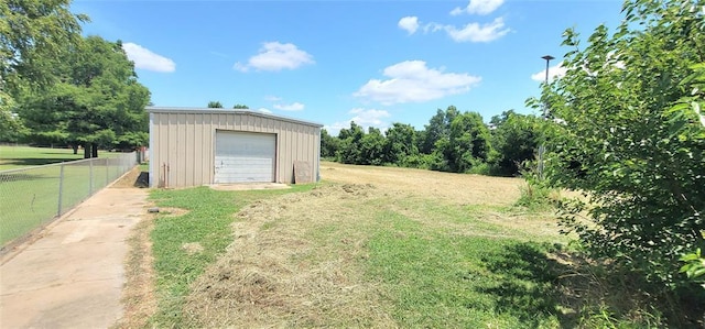 1117 Moose St, Yukon, OK 73099 - view of yard featuring a garage, driveway, and an outdoor structure
