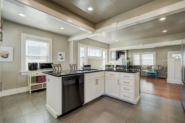 2233 W Eubanks St, Oklahoma City, OK 73112 - kitchen with dishwasher, tile patterned flooring, open floor plan, dark countertops, and recessed lighting
