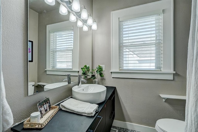 2233 W Eubanks St, Oklahoma City, OK 73112 - bathroom with plenty of natural light, vanity, and a textured wall
