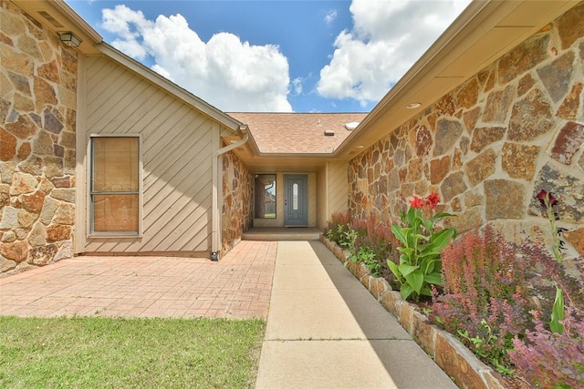 3121 SW 128th St, Oklahoma City, OK 73170 - view of exterior entry with stone siding and a patio