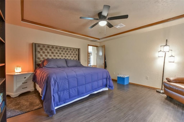 3121 SW 128th St, Oklahoma City, OK 73170 - bedroom with wood finished floors, a raised ceiling, and a ceiling fan