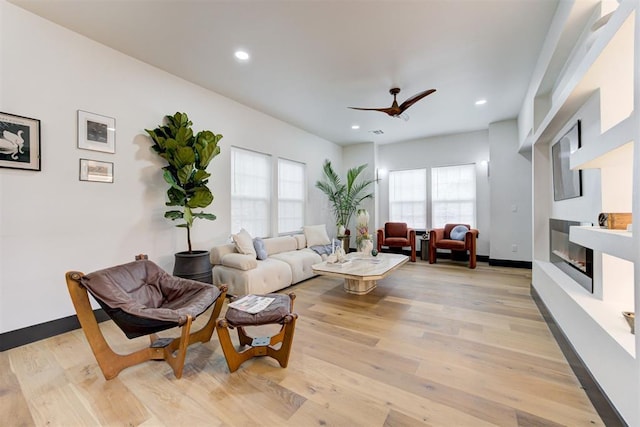 1432 NE Euclid St, Oklahoma City, OK 73117 - living area featuring a glass covered fireplace, light wood finished floors, a ceiling fan, and recessed lighting
