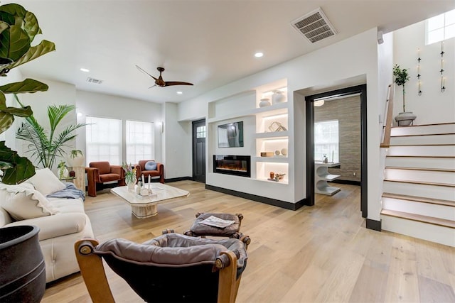 1432 NE Euclid St, Oklahoma City, OK 73117 - living area with ceiling fan, stairs, light wood finished floors, a glass covered fireplace, and recessed lighting