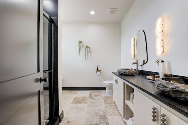 1432 NE Euclid St, Oklahoma City, OK 73117 - bathroom with double vanity, a shower stall, stone finish flooring, and recessed lighting