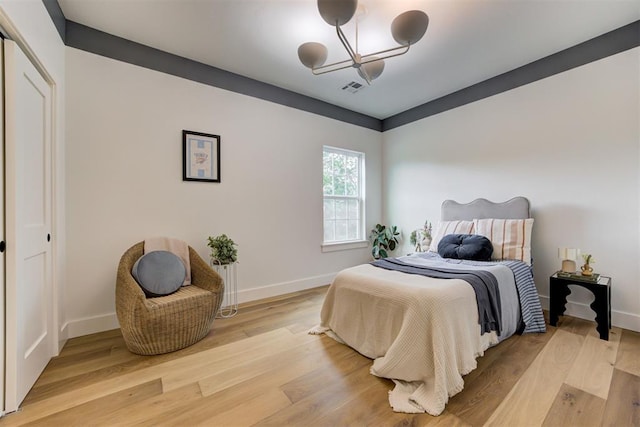 1432 NE Euclid St, Oklahoma City, OK 73117 - bedroom with a chandelier and light wood-style floors