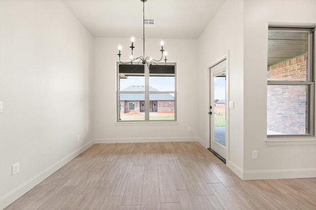 11713 NW 105th St, Yukon, OK 73099 - unfurnished dining area with a chandelier and wood finished floors