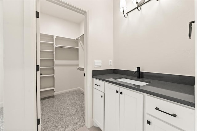 11713 NW 105th St, Yukon, OK 73099 - bathroom featuring vanity and a walk in closet