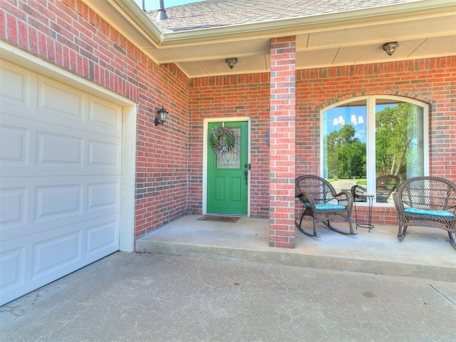 73 Sonata Ln, Shawnee, OK 74804 - property entrance featuring brick siding, roof with shingles, and a garage