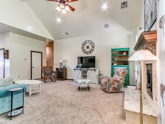 73 Sonata Ln, Shawnee, OK 74804 - carpeted living room featuring high vaulted ceiling, a ceiling fan, and a glass covered fireplace