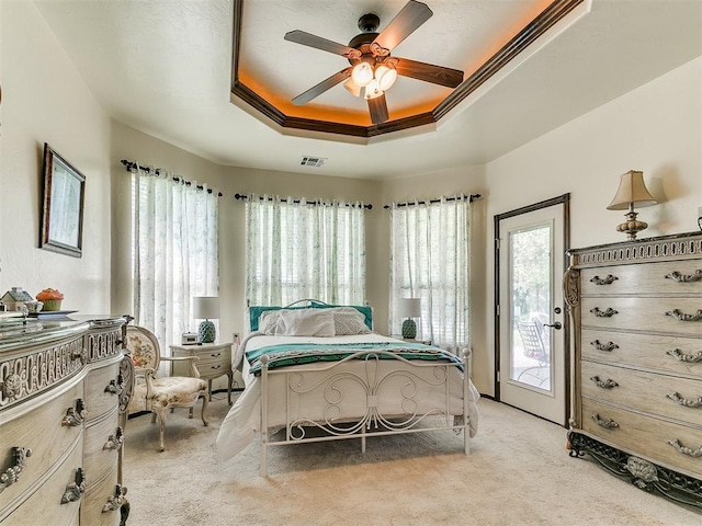 73 Sonata Ln, Shawnee, OK 74804 - carpeted bedroom featuring multiple windows, access to exterior, a raised ceiling, and ceiling fan