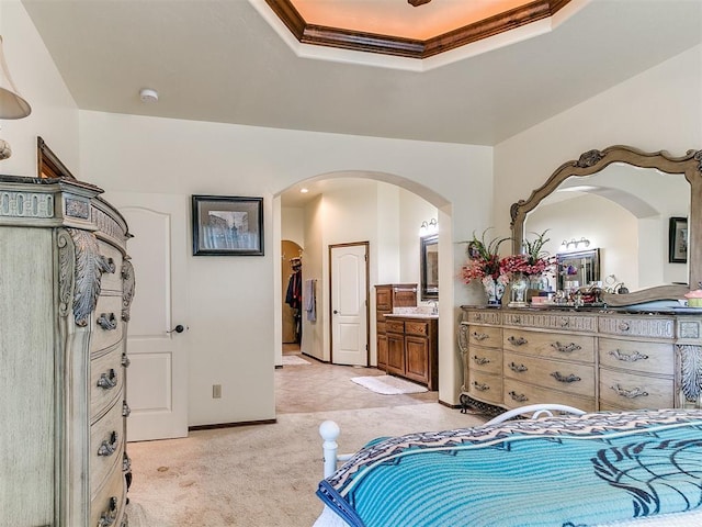73 Sonata Ln, Shawnee, OK 74804 - bedroom with arched walkways, light colored carpet, ensuite bathroom, a tray ceiling, and crown molding