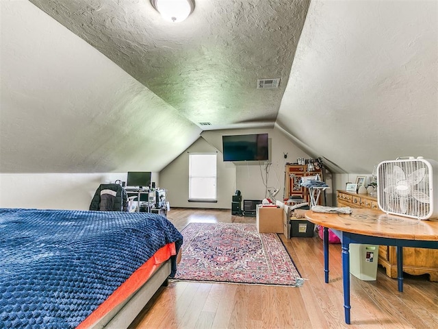73 Sonata Ln, Shawnee, OK 74804 - bedroom with wood finished floors, a textured ceiling, and lofted ceiling
