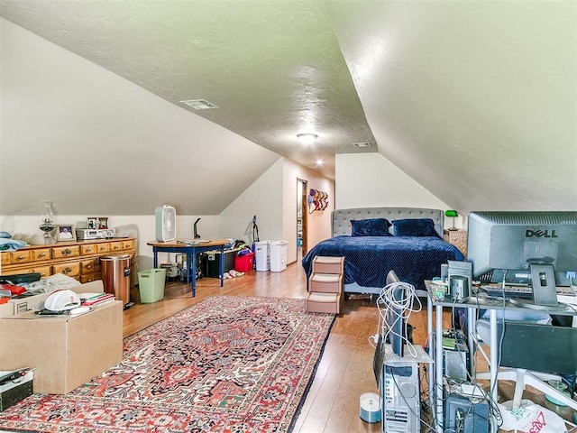 73 Sonata Ln, Shawnee, OK 74804 - bedroom with hardwood / wood-style flooring, lofted ceiling, and a textured ceiling