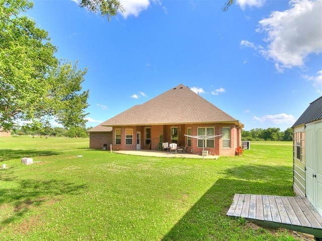 73 Sonata Ln, Shawnee, OK 74804 - back of property featuring a patio, a lawn, and brick siding