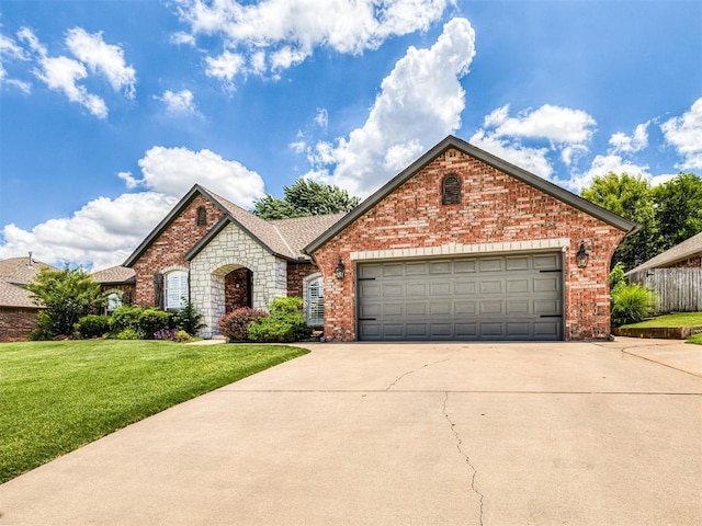 2044 Yorkshire Dr, Midwest City, OK 73130 - view of front of home featuring a garage, concrete driveway, a front yard, brick siding, and roof with shingles