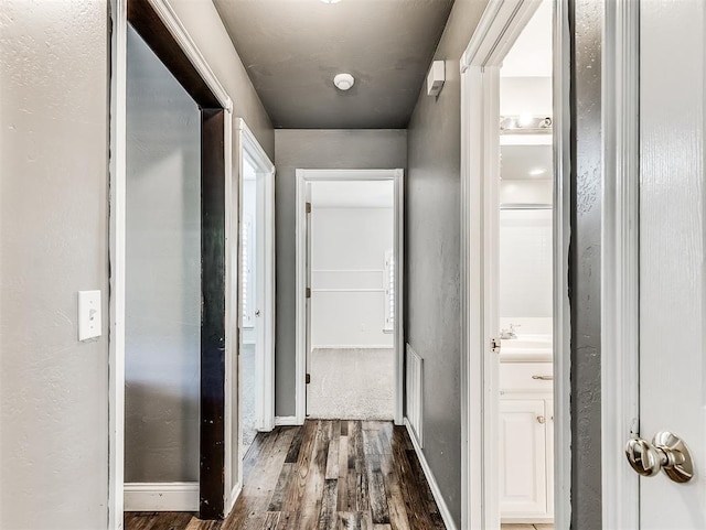2044 Yorkshire Dr, Midwest City, OK 73130 - hallway featuring dark wood finished floors and baseboards