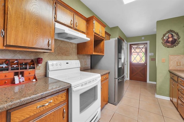 22117 E 1250th Rd, Rocky, OK 73661 - kitchen with white electric stove, under cabinet range hood, brown cabinetry, tasteful backsplash, and light tile patterned floors