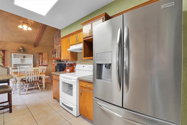 22117 E 1250th Rd, Rocky, OK 73661 - kitchen with stainless steel fridge with ice dispenser, white electric range oven, under cabinet range hood, light tile patterned flooring, and brown cabinetry