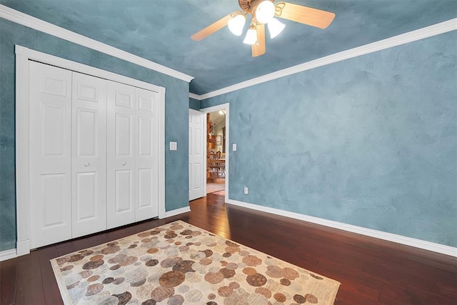 22117 E 1250th Rd, Rocky, OK 73661 - unfurnished bedroom featuring hardwood / wood-style floors, a ceiling fan, crown molding, and a closet