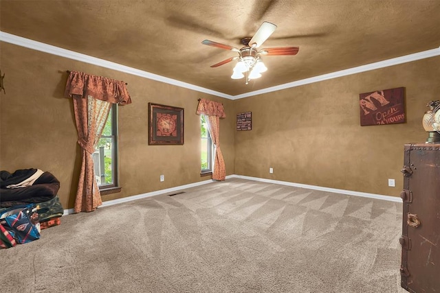 22117 E 1250th Rd, Rocky, OK 73661 - spare room featuring a ceiling fan, carpet floors, a textured ceiling, and crown molding