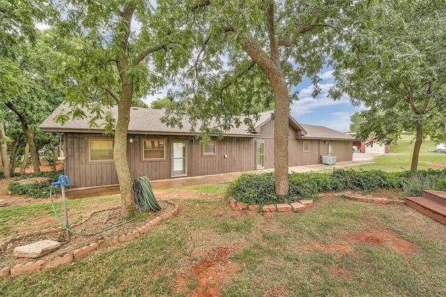 22117 E 1250th Rd, Rocky, OK 73661 - rear view of property with a patio area, a lawn, roof with shingles, and board and batten siding