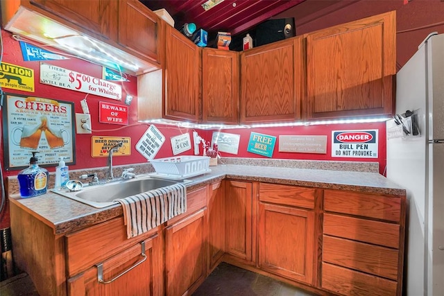 22117 E 1250th Rd, Rocky, OK 73661 - kitchen with white fridge with ice dispenser, brown cabinets, and light countertops