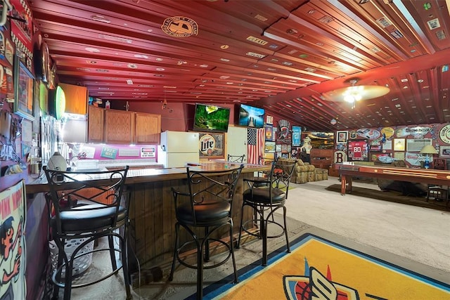 22117 E 1250th Rd, Rocky, OK 73661 - indoor dry bar with freestanding refrigerator, carpet floors, lofted ceiling, and a ceiling fan