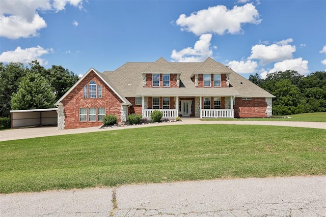 11409 SW 109th St, Mustang, OK 73064 - view of front of home featuring driveway, a porch, a front lawn, and brick siding