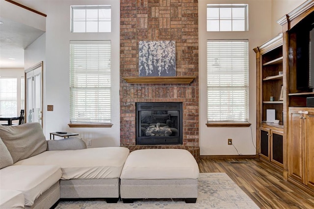 11409 SW 109th St, Mustang, OK 73064 - living area with wood finished floors and a brick fireplace