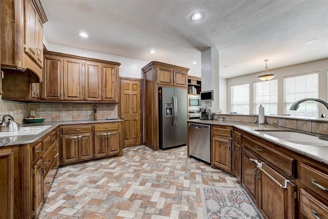 11409 SW 109th St, Mustang, OK 73064 - kitchen with stainless steel appliances, tasteful backsplash, recessed lighting, and brown cabinetry