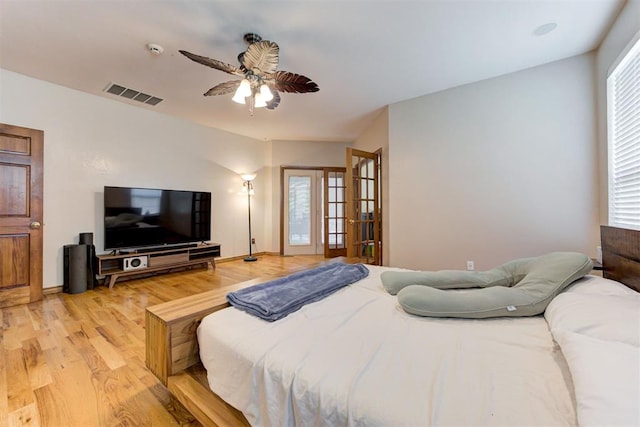 11409 SW 109th St, Mustang, OK 73064 - bedroom with light wood-style flooring, ceiling fan, and french doors