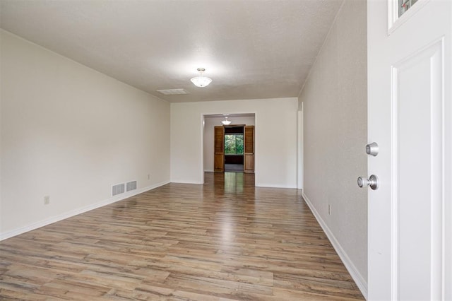 521 NW 50th St, Oklahoma City, OK 73118 - spare room featuring light wood-style floors and a textured ceiling