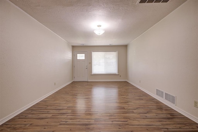 521 NW 50th St, Oklahoma City, OK 73118 - spare room featuring wood finished floors and a textured ceiling