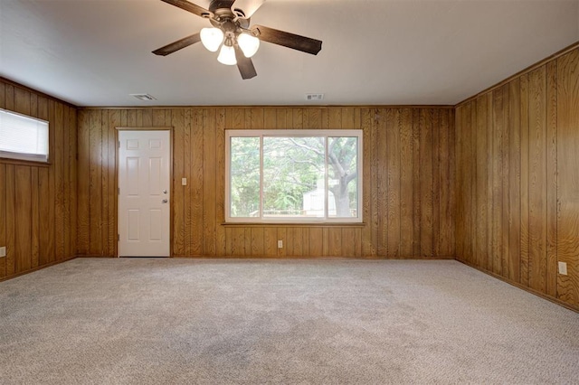521 NW 50th St, Oklahoma City, OK 73118 - carpeted empty room featuring a ceiling fan and wood walls