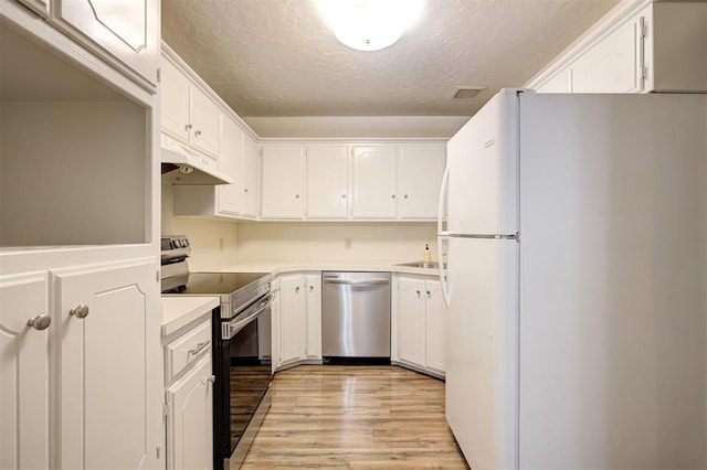 521 NW 50th St, Oklahoma City, OK 73118 - kitchen with stainless steel appliances, under cabinet range hood, a textured ceiling, light wood finished floors, and white cabinets