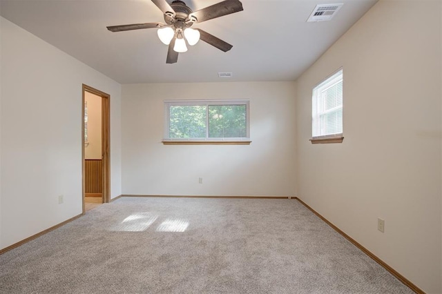 521 NW 50th St, Oklahoma City, OK 73118 - spare room featuring light carpet and ceiling fan