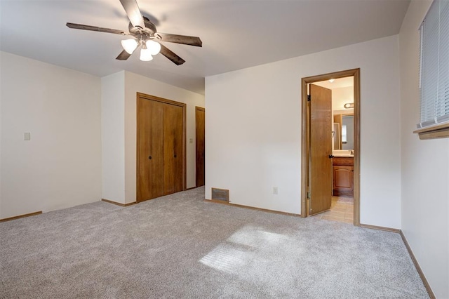 521 NW 50th St, Oklahoma City, OK 73118 - unfurnished bedroom with carpet floors, connected bathroom, and ceiling fan