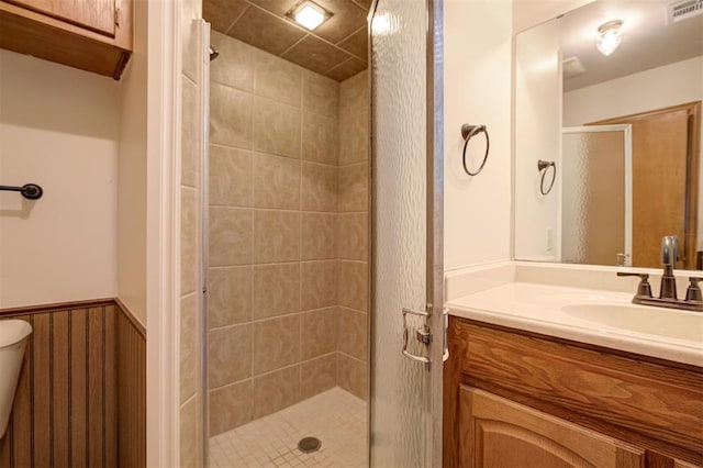 521 NW 50th St, Oklahoma City, OK 73118 - bathroom with a stall shower, vanity, and wainscoting