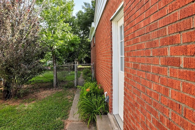 521 NW 50th St, Oklahoma City, OK 73118 - view of side of home featuring brick siding and a gate