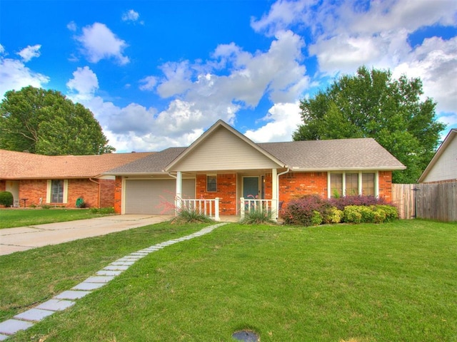 700 S Willowood Dr, Yukon, OK 73099 - ranch-style home with covered porch, an attached garage, brick siding, and concrete driveway