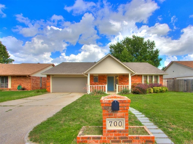 700 S Willowood Dr, Yukon, OK 73099 - single story home featuring a porch, an attached garage, driveway, and brick siding