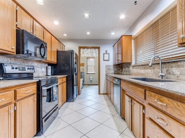 700 S Willowood Dr, Yukon, OK 73099 - kitchen featuring black appliances, backsplash, a textured ceiling, light tile patterned floors, and recessed lighting