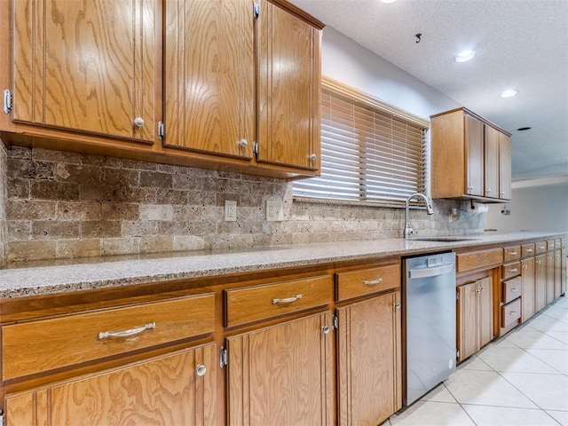 700 S Willowood Dr, Yukon, OK 73099 - kitchen with dishwasher, light tile patterned floors, backsplash, light stone counters, and recessed lighting