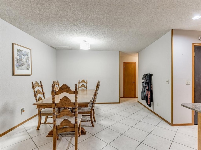 700 S Willowood Dr, Yukon, OK 73099 - dining area with light tile patterned floors and a textured ceiling