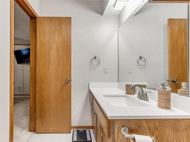 700 S Willowood Dr, Yukon, OK 73099 - bathroom featuring vanity and a textured wall