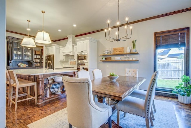 9020 NW 147th Ter, Yukon, OK 73099 - dining area featuring crown molding, wood finished floors, a chandelier, and recessed lighting