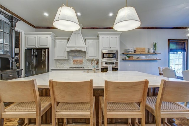 9020 NW 147th Ter, Yukon, OK 73099 - kitchen with stainless steel appliances, crown molding, tasteful backsplash, white cabinets, and hanging light fixtures