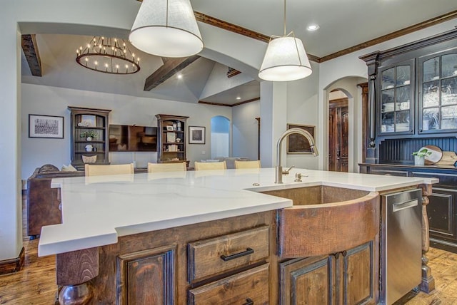 9020 NW 147th Ter, Yukon, OK 73099 - kitchen with arched walkways, wood finished floors, dishwasher, hanging light fixtures, and recessed lighting